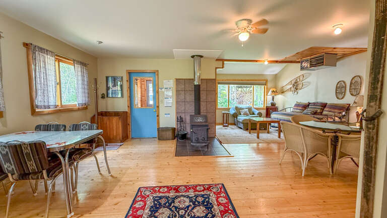 Your cozy cabin retreat features warm wood floors, a crackling fireplace, and open living spaces perfect for gathering with loved ones.