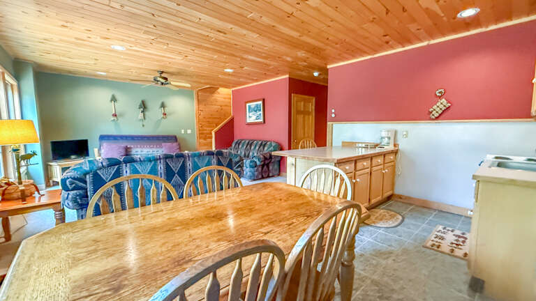 Gather at your private dining table, where rustic wood meets vibrant color and warmth. Just beyond, your cozy living space invites you to unwind after a day exploring.
