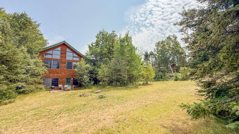 A private mountain retreat surrounded by natural landscape and towering trees, offering a tranquil escape in a peaceful, wooded setting.