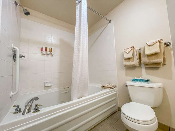 The bathroom features a jetted tub/shower combo The bathroom features a jetted tub/shower combo