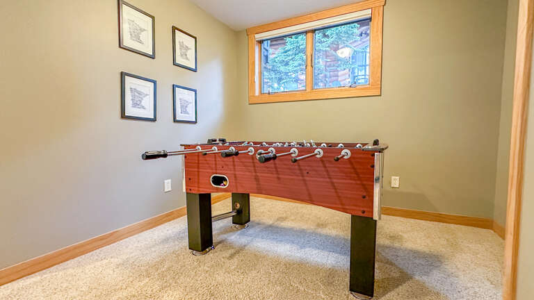 There is a foosball table in the lower level family room.