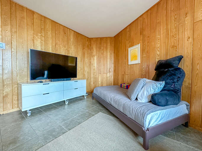This bedroom also serves as the family room with a TV.