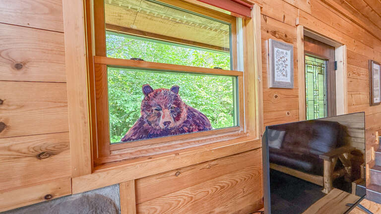 Rustic charm meets artistic warmth in this cozy nook, where you'll relax amid natural wood walls and thoughtful bear-themed touches.