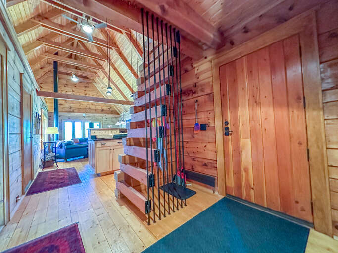 Entryway and loft ladder of Ravencliff, leading to the open layout living area.