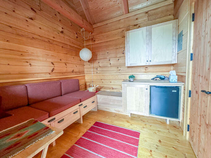 The sauna building has a small sitting area.