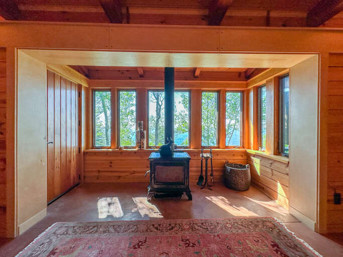 The lower level living room also has a wood-burning stove.