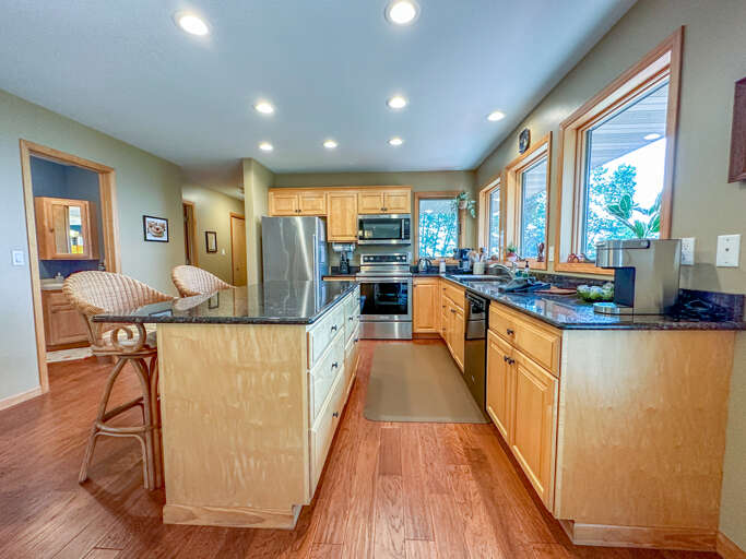The kitchen features stainless steel appliances and granite countertops.
