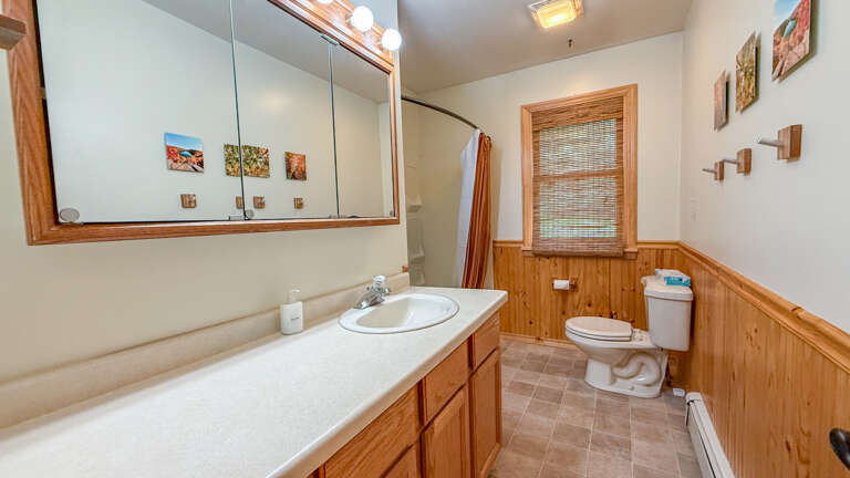 Freshen up in your private bathroom with warm wood tones and natural light. The spacious layout gives you room to unwind after a day of exploring.