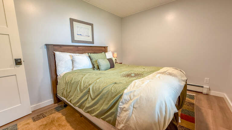 Slip into your cozy bedroom retreat where soft linens and calming tones invite restful nights. The warm wood furniture and soothing color palette create a peaceful sanctuary for you to unwind after exploring.