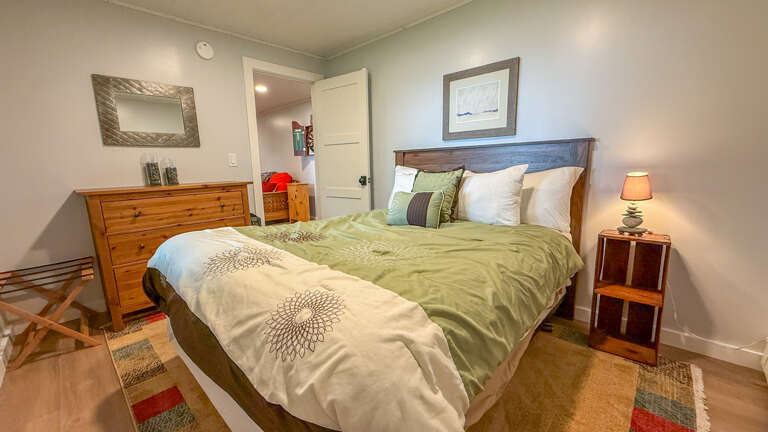 Sink into crisp linens and let the calming tones ease you into a peaceful night's rest. Your cozy bedroom retreat features soft lighting, warm wood accents, and all the space you need to unwind.