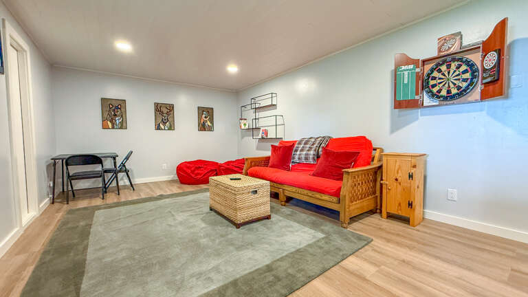 Settle in for game night on your cozy futon with a dartboard ready for friendly competition—perfect for unwinding after exploring the area.