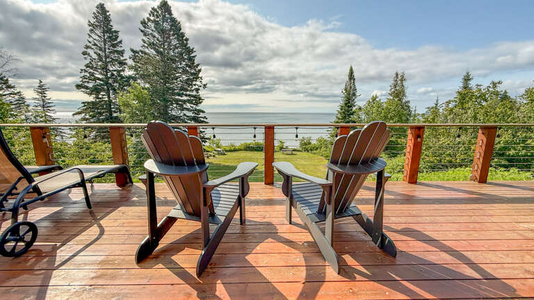 Settle into comfortable Adirondack chairs on your private deck, where panoramic views of serene waters and lush greenery stretch before you. Perfect for morning coffee or sunset relaxation.