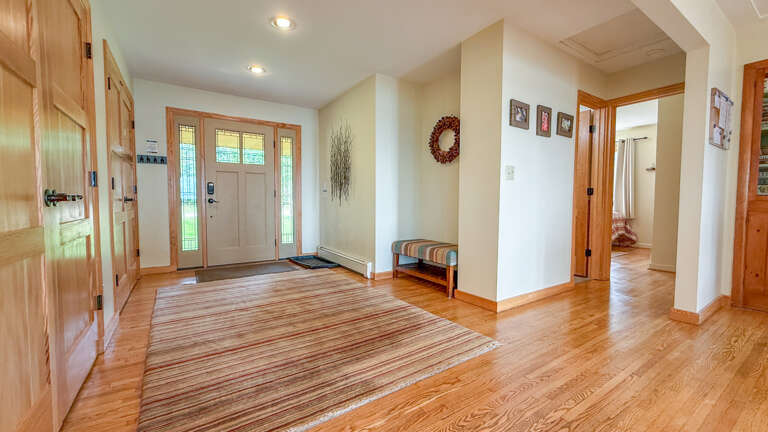 Step through the front door into a welcoming entryway with gleaming wood floors and natural light streaming in. Your home away from home starts here, where warmth and comfort greet you at arrival.