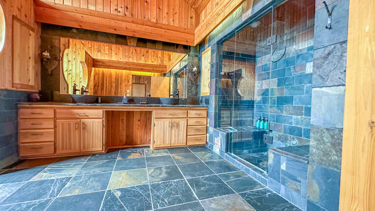 Bathroom 1 is attached to Bedroom 1 and has a separate shower and jetted tub.