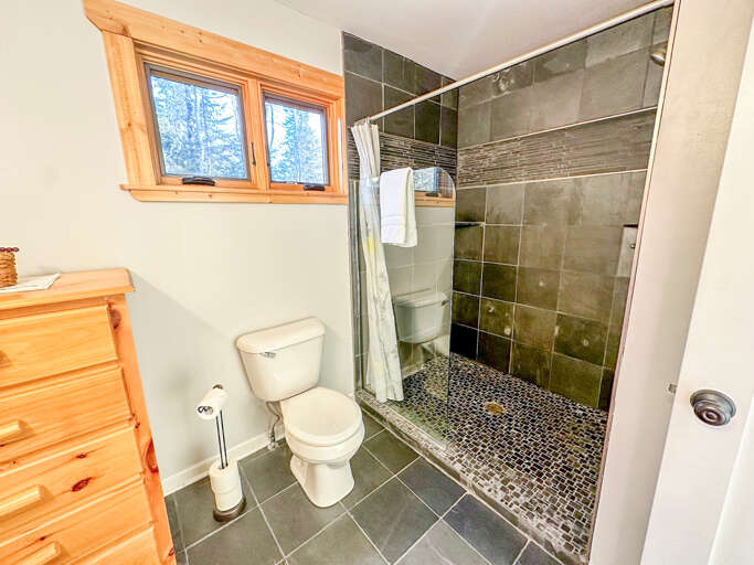 The bathroom features a spacious walk-in shower.