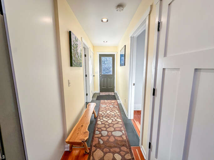 Bedroom and bathroom hallway looking at the front door.