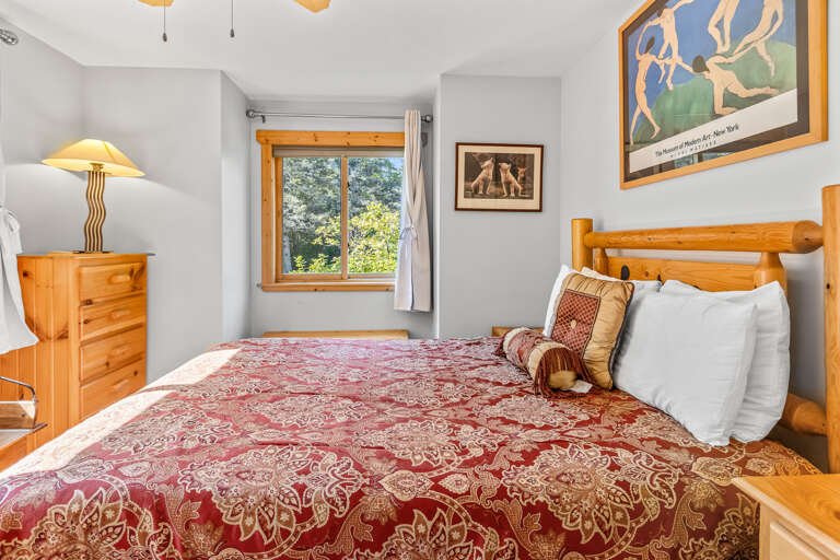 Main floor bedroom with plenty of sunny windows