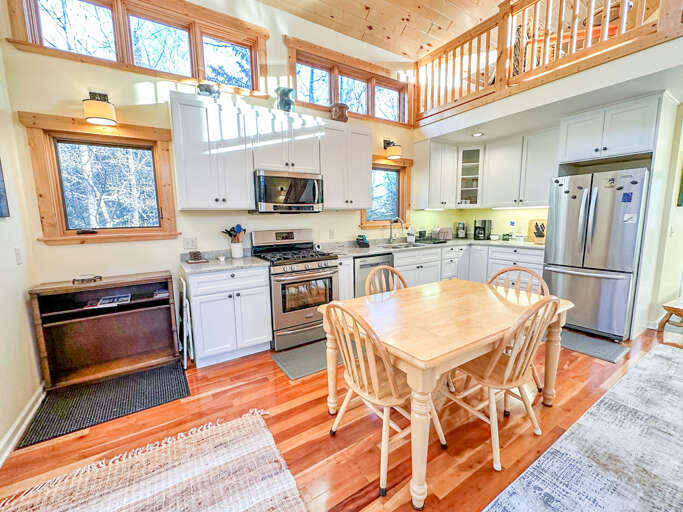The kitchen features marble countertops and stainless steel appliances.