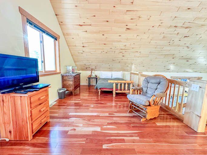The loft space is open to the living area below and features two futons that fold out into queen sized beds.