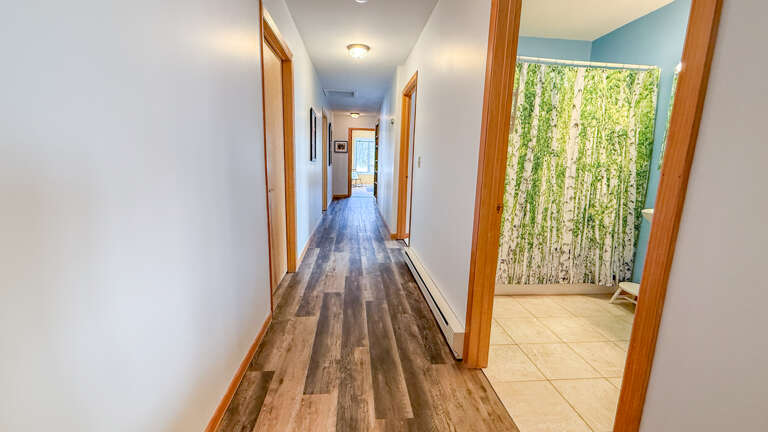 The bedrooms and bathrooms are located down the hallway off the living area.