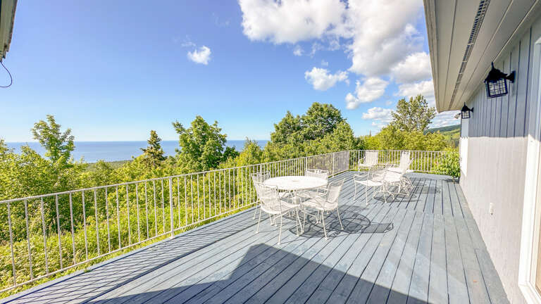 The lake-facing deck is located off of the sunroom.