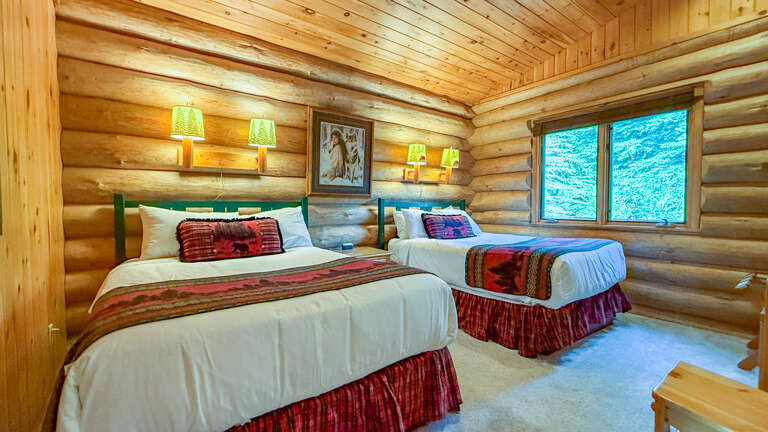 Sink into plush beds dressed in rich textiles under the warm glow of wood-beam ceilings, while mountain views stretch beyond your window.