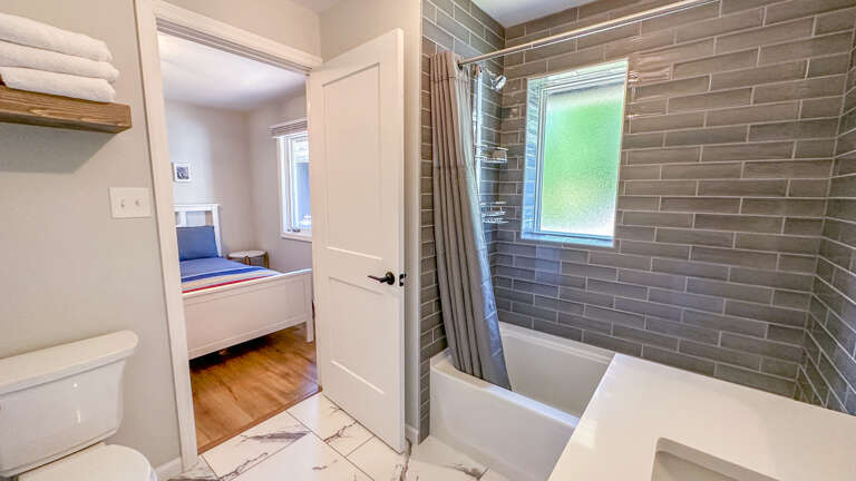 Bathroom 1 is attached to the entryway and Bedroom 1.