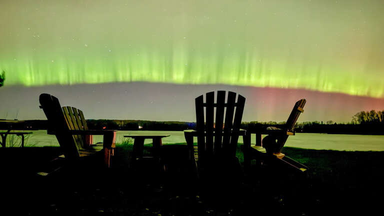 Northern Lights visible from the fire pit area.