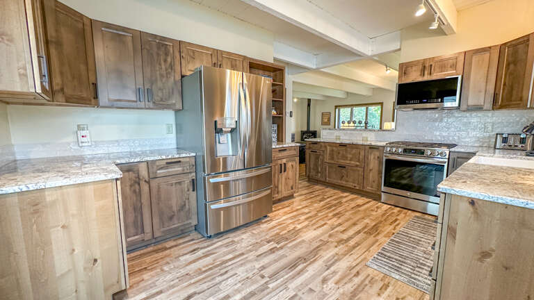 The chef's kitchen boasts granite countertops and high-end stainless steel appliances. The chef's kitchen boasts granite countertops and high-end stainless steel appliances.
