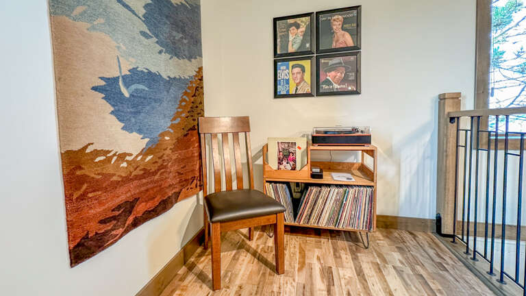 A vinyl record player and an impressive collection of albums await in a dedicated corner of the living space. A vinyl record player and an impressive collection of albums await in a dedicated corner of the living space.