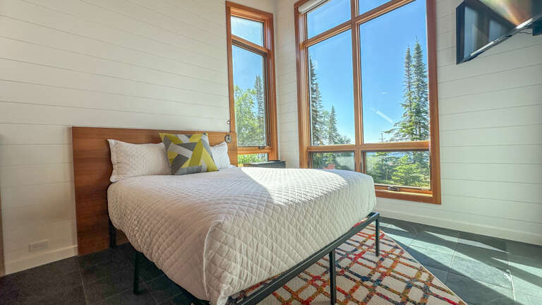 Like Bedroom 1, Bedroom 2 has floor to ceiling and wall to wall windows.