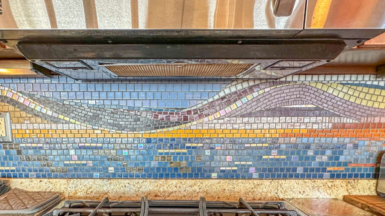 Custom Lake Superior-themed tile work in the kitchen.