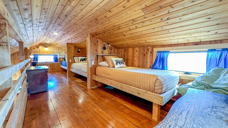 The sleeping area has three twin beds.