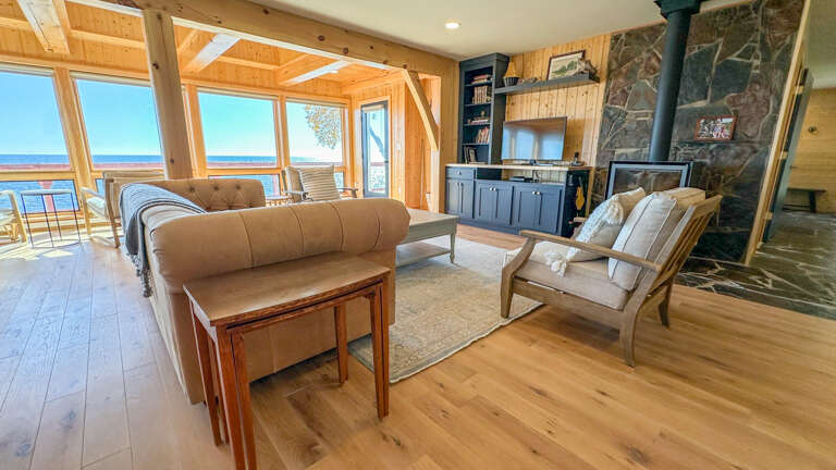 There is a TV and wood stove in the living room.