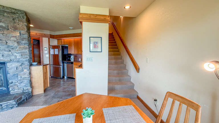 The dining area, staircase required to access the condo, and the kitchen. The dining area, staircase required to access the condo, and the kitchen.