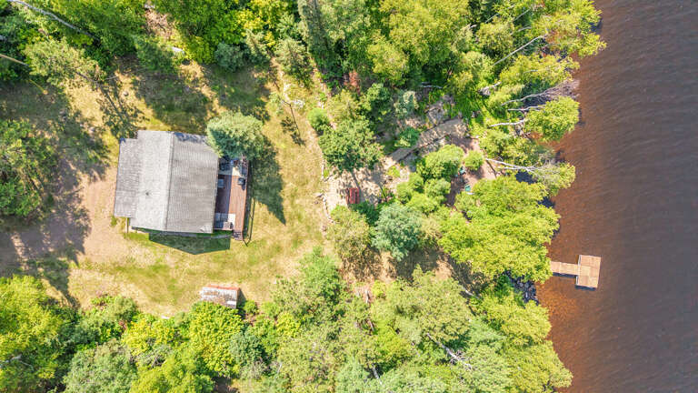 Aerial view of the cabin, spacious yard space, and the private waterfront area. Aerial view of the cabin, spacious yard space, and the private waterfront area.