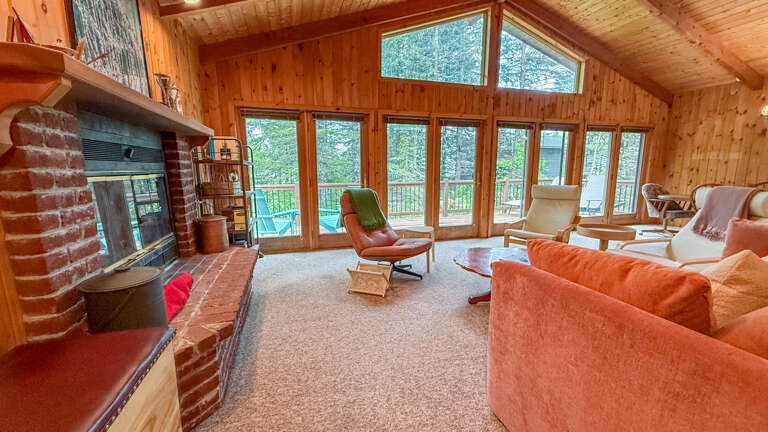 Living room with brick wood-burning fireplace.
