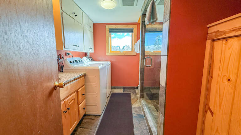 Lower level bathroom with washer and dryer.