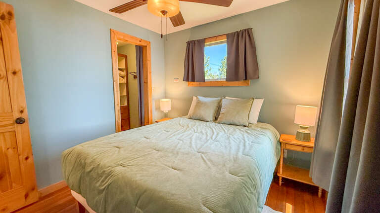 Drift into restful sleep in your peaceful bedroom, where soft bedding and warm natural light create your perfect mountain retreat.