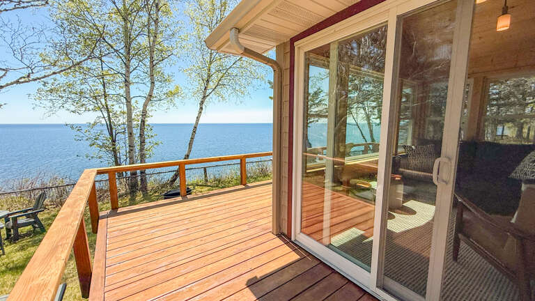 Step onto your private deck and breathe in the fresh lakeside air. Imagine your mornings here, coffee in hand, watching the water shimmer through the trees as peaceful waves create the perfect backdrop for your getaway.