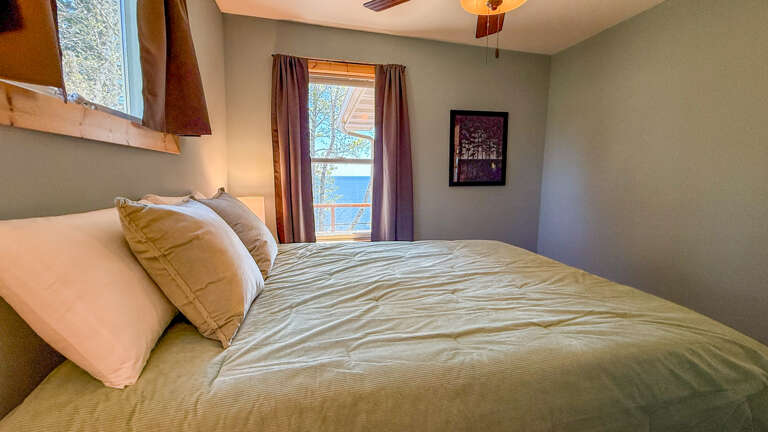 Wake to gentle morning light and stunning water views framed by your window, where crisp linens and soft pillows promise restful nights in your serene retreat.