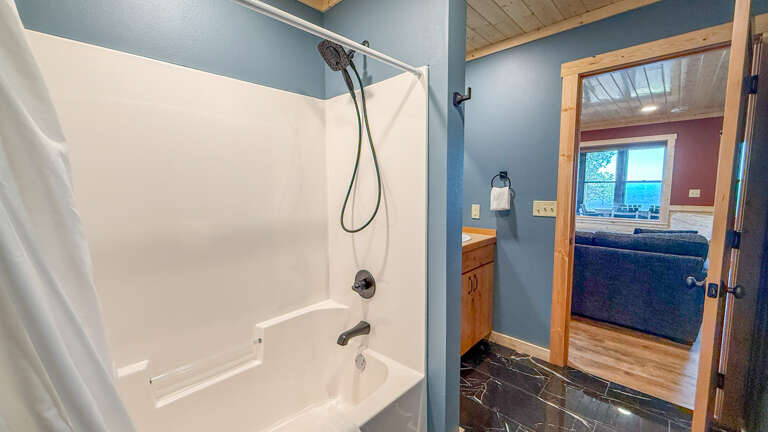Freshen up in your private bathroom featuring a full tub-shower combo, perfect for unwinding after a day of adventure or simply starting your morning right.