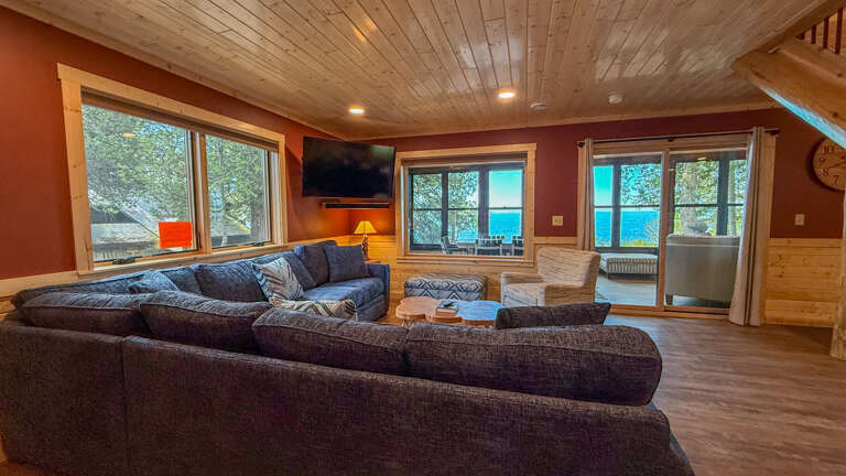 Sink into plush sofas and gaze at stunning lake vistas through expansive windowsâyour peaceful retreat where comfort meets breathtaking waterfront views.