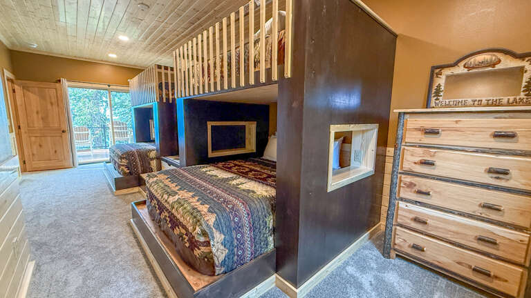 Slide into your cozy lakeside retreat with its rustic charm, handcrafted wooden accents, and a bunk bed perfect for families. Soft natural light and warm tones invite restful evenings.