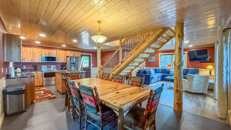 Step into your private mountain retreat where rustic log beams frame an open-concept haven. Cook, dine, and gather under vaulted wood ceilings with natural light streaming through picture windows.