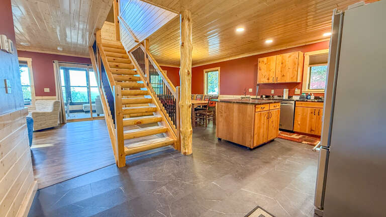 Step into your rustic-modern retreat with soaring wood ceilings and an open loft. Natural light pours through skylights while a fully equipped kitchen and dining space invite you to cook and gather.