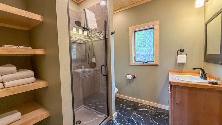 The upper level bathroom features a walk-in shower.