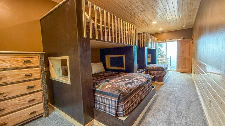 Slide into your cozy bunk and feel the rustic charm of natural wood all around. Perfect for families, this space sleeps everyone comfortably with mountain lodge style and easy access to the outdoors.