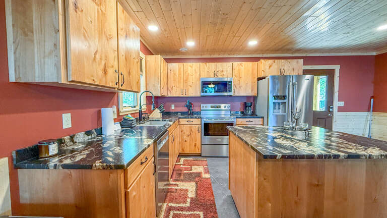 Your spacious, fully-equipped kitchen awaitsâboasting elegant granite counters, stainless steel appliances, a gas stove, and microwave. Warm wood cabinetry and earthy tones create a welcoming space to cook and gather.