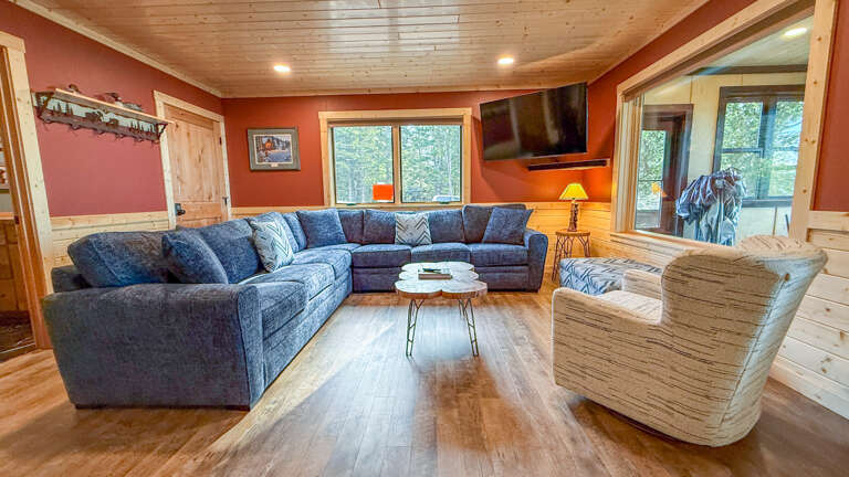 Stretch out on the spacious sectional and unwind beneath warm wood ceilings, with natural light streaming in and your favorite shows ready on the flatscreenâyour perfect mountain retreat awaits.